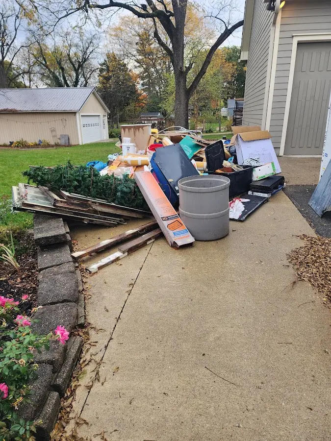 Dumpster being loaded with debris for Roofing Dumpster Rental in Indian Head Park